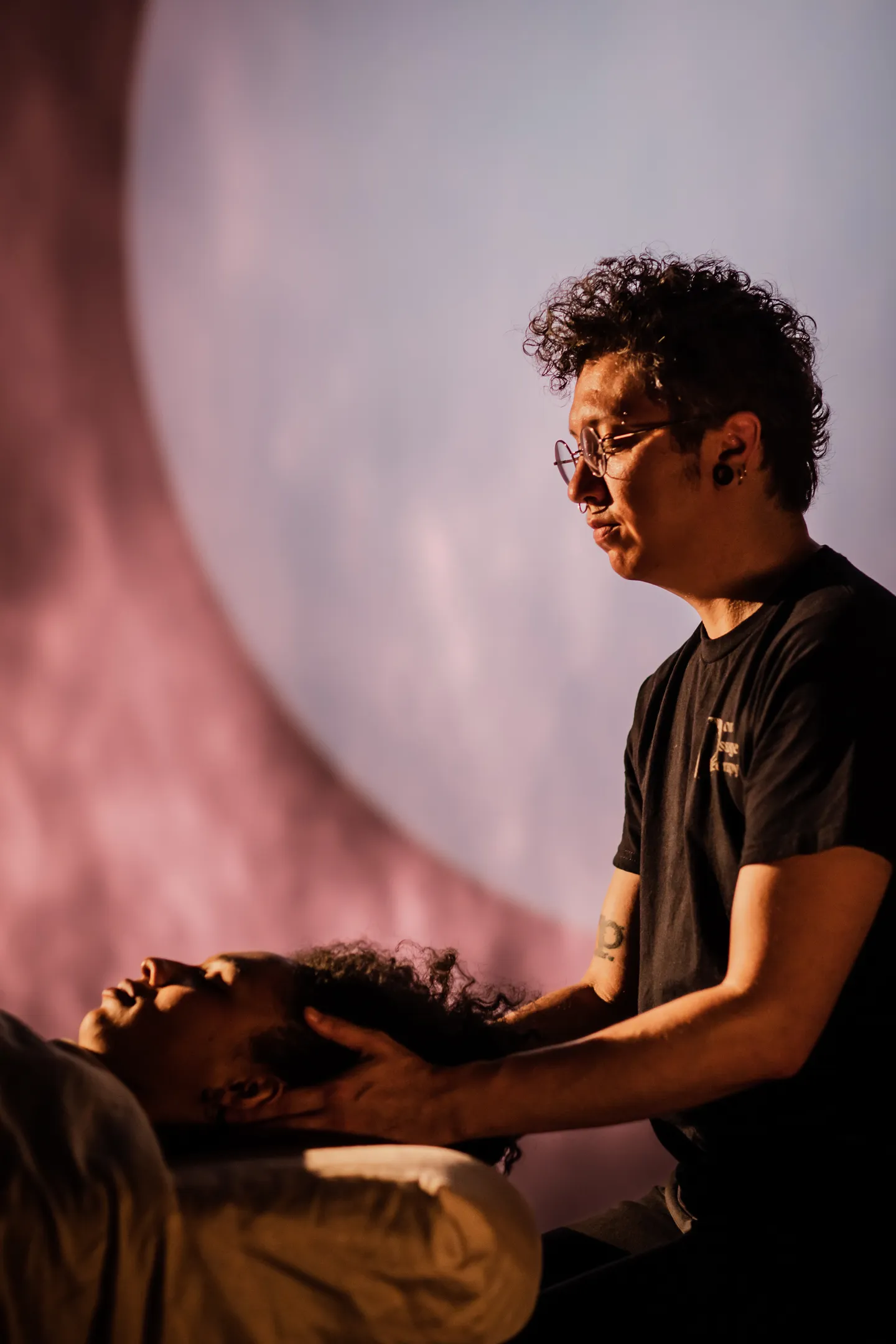 Fox holding client's head during a reiki massage with a moon in the background.