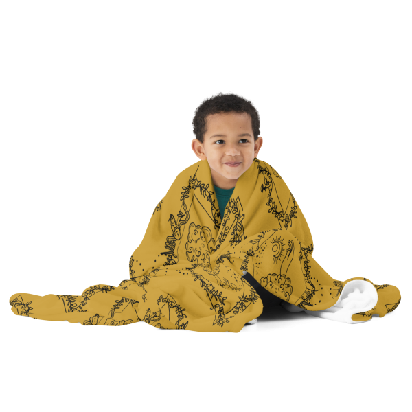 Small child with short brown hair wrapped up in a gold throw blanket.