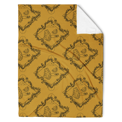 Gold throw blanket with the a repeating pattern of a line drawing with a diamond shaped frame. In the center, is a tarot-esque floating hand with a crescent moon. Surrounding the hand is a vine with owl, mushrooms, crystals, moon flowers, a snake, and skull.