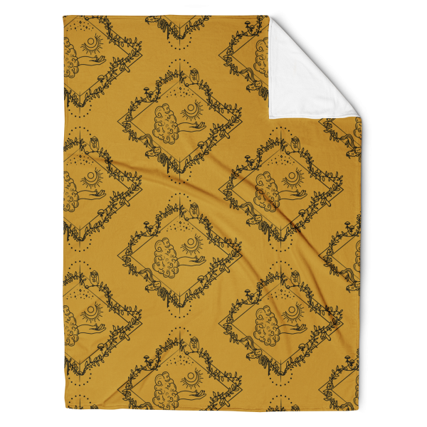 Gold throw blanket with the a repeating pattern of a line drawing with a diamond shaped frame. In the center, is a tarot-esque floating hand with a crescent moon. Surrounding the hand is a vine with owl, mushrooms, crystals, moon flowers, a snake, and skull.