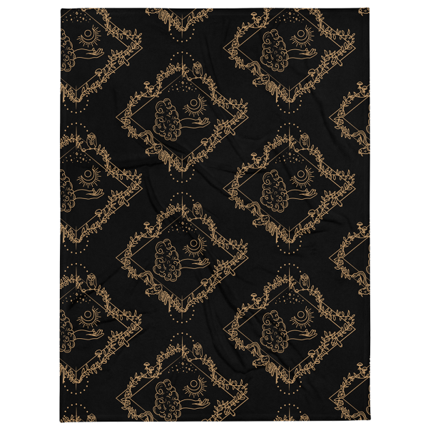 Black throw blanket with the a repeating pattern of a line drawing with a diamond shaped frame. In the center, is a tarot-esque floating hand with a crescent moon. Surrounding the hand is a vine with owl, mushrooms, crystals, moon flowers, a snake, and skull.